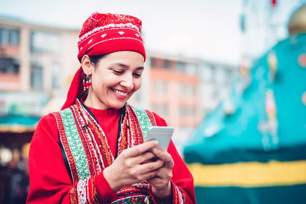 A young woman relaxing with her phone while dynamic casino elements float around her, illustrating the smooth mobile experience offered by the F7 F7 app.